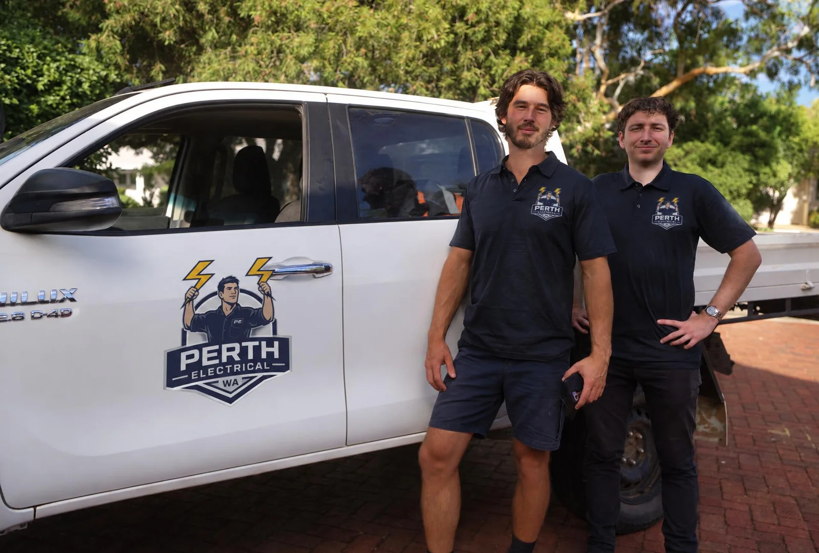 Electrician Perth team beside their branded work vehicle